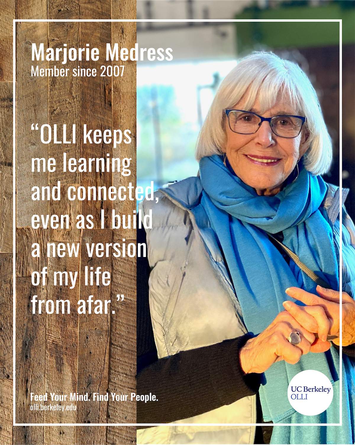Smiling Marjorie leaning against a wall, staring at camera