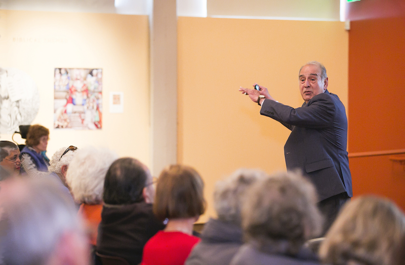 Faculty member teaching in front of members